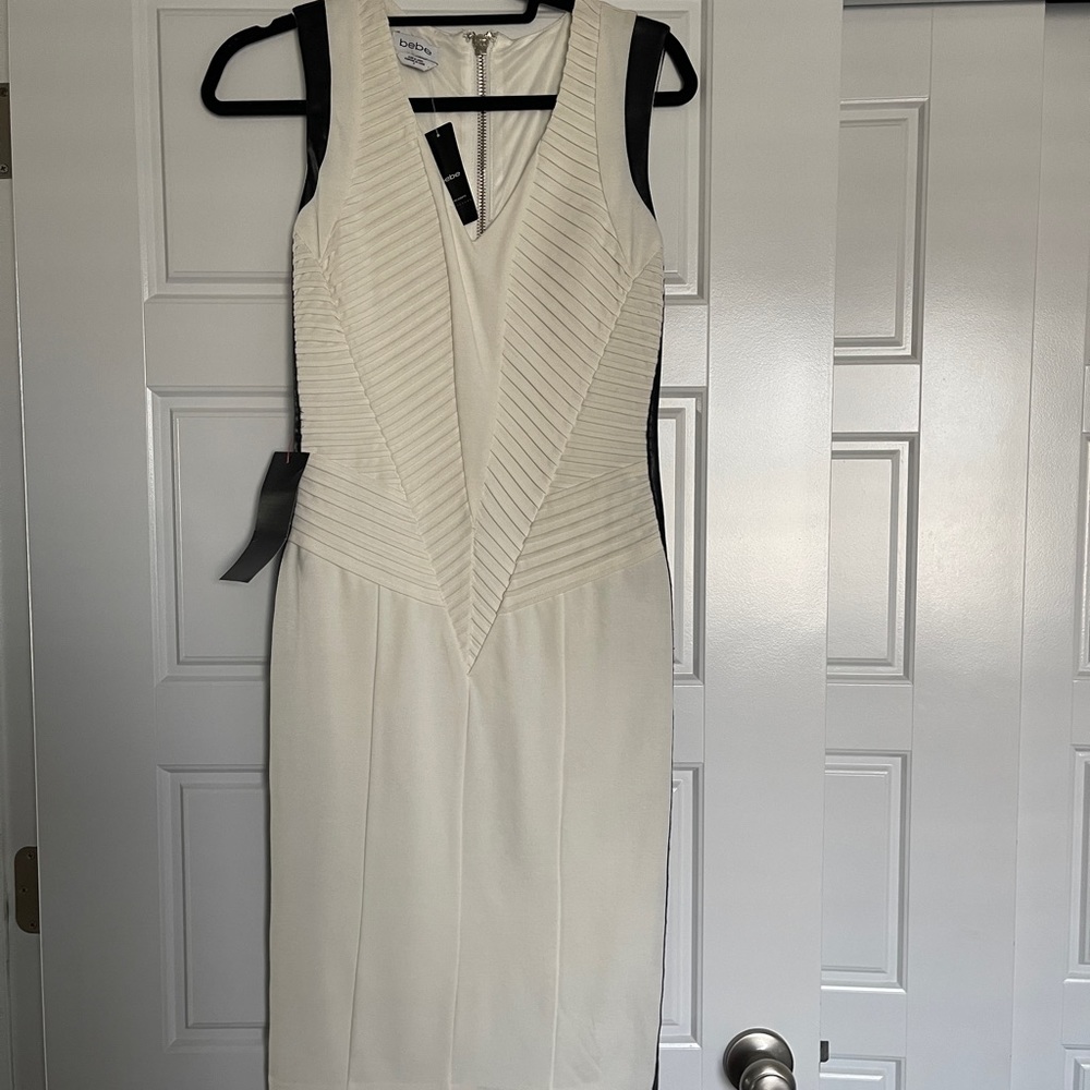 Gorgeous off white with black faux leather trim